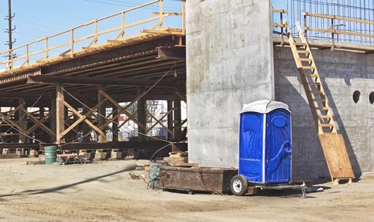 rows of porta potties at a construction site, providing essential amenities for workers